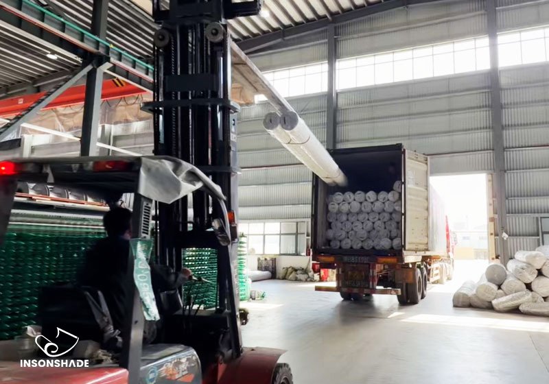 Forklift loading climate screen rolls into a truck for shipment from INSONSHADE factory