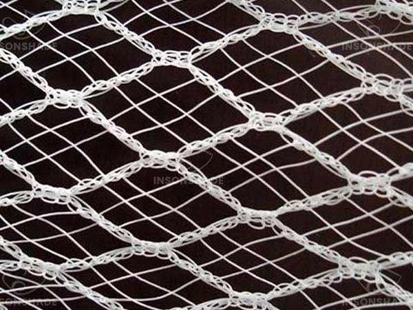 Close-up of an anti-hail net mesh opening and reinforced yarn pattern